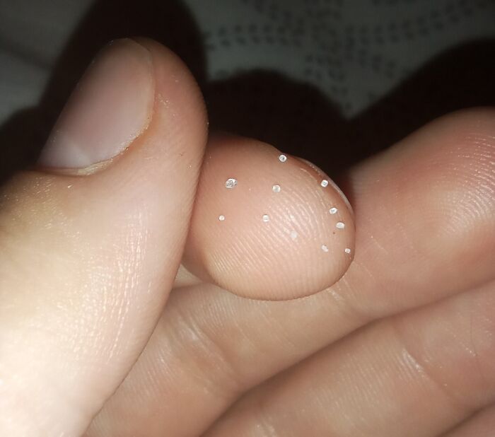 A hand holding tiny white crystals, representing a lack of basic human decency.