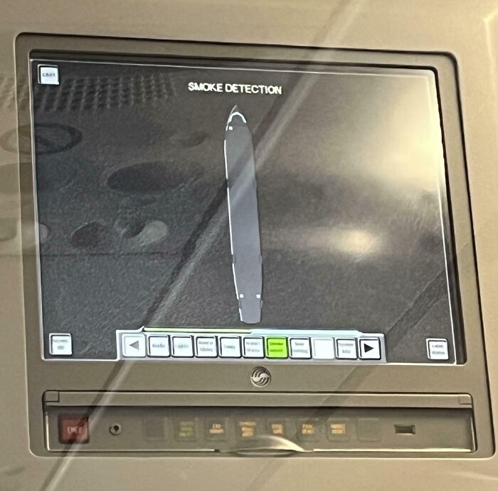 A smoke detection screen on an airplane, indicating a potential lack of basic human decency from a passenger.