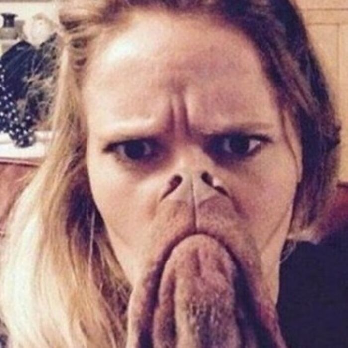 A person with a bulldog's snout and jowls over their mouth, creating a funny optical illusion. A clever 'When You See It' picture.