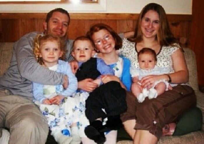 A family of six on a couch with an extra person hiding, a When You See It picture.