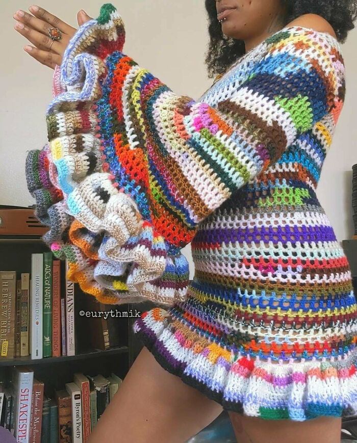 Colorful crochet dress made from repurposed yarn with ruffled sleeves