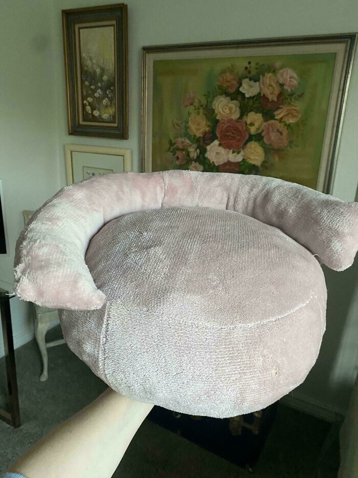 Fluffy pink cushion, an unexpected thing made out of things that would have been thrown away, held by a hand.