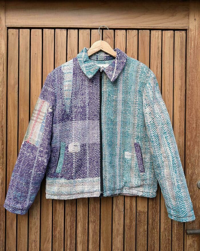 A handmade jacket made from things that would have been thrown away, featuring a quilted patchwork of purple and blue fabrics.