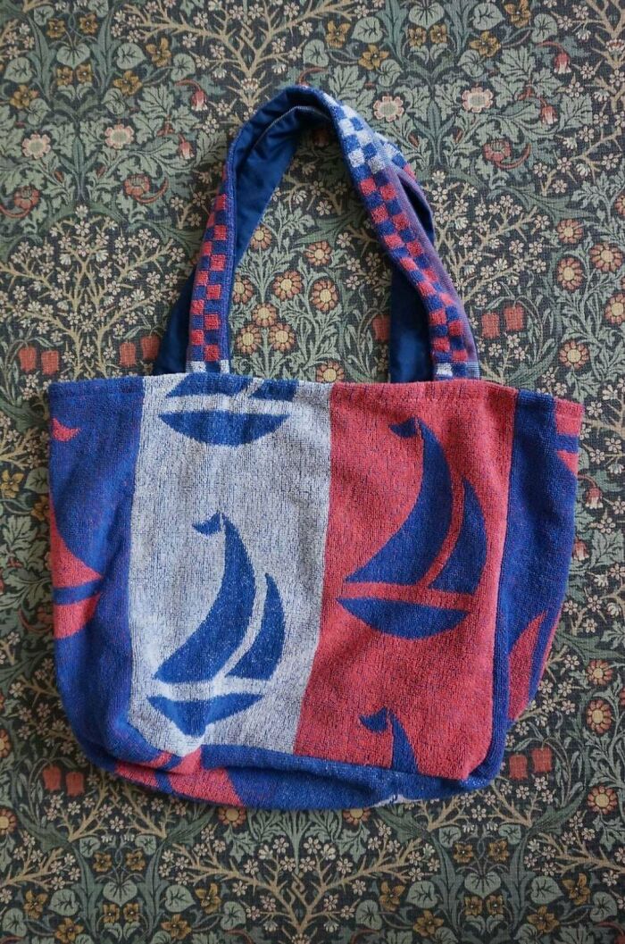 A colorful tote bag made from repurposed towels, a clever example of things people made out of things that would've been thrown away.