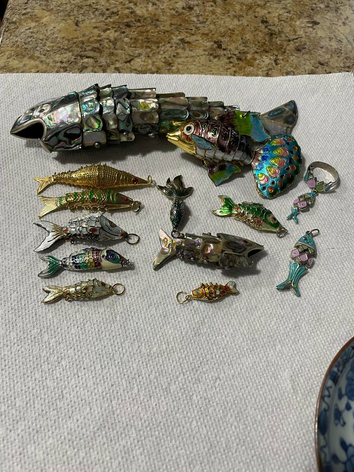 An array of intricately designed fish figurines and jewelry, part of fascinating collections people build.