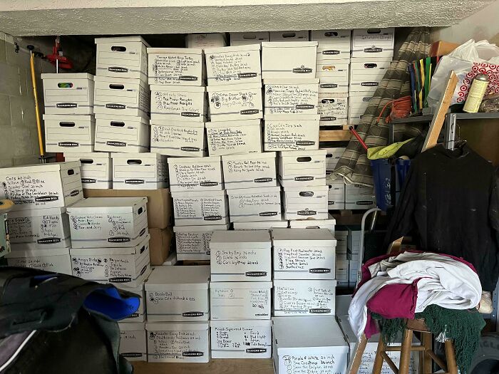 A garage packed with an unexpected collection of neatly stacked white storage boxes, showcasing various collections.