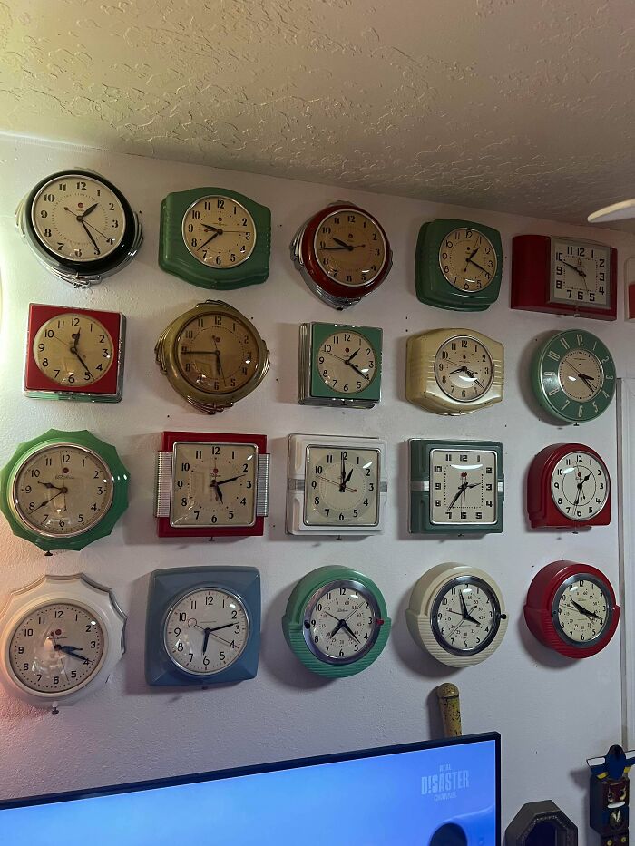 A wall displaying numerous vintage and retro clocks, forming a fascinating collection of timepieces.