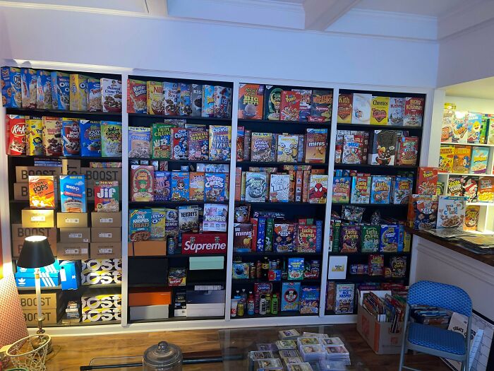 A large wall entirely covered with a diverse collection of cereal boxes, meticulously displayed, a fascinating collection.