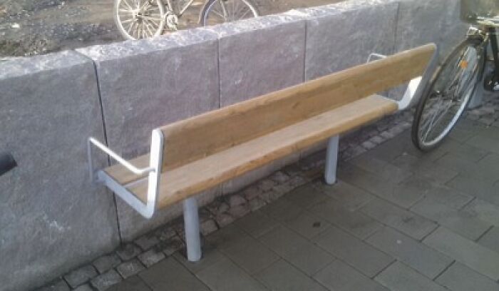 A poorly designed public bench that is too narrow for comfortable sitting, showcasing an architecture and design fail.