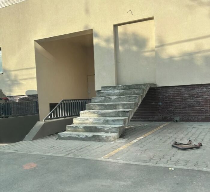 Amusing architecture and design fails: outdoor concrete stairs leading to a closed wall on a building.