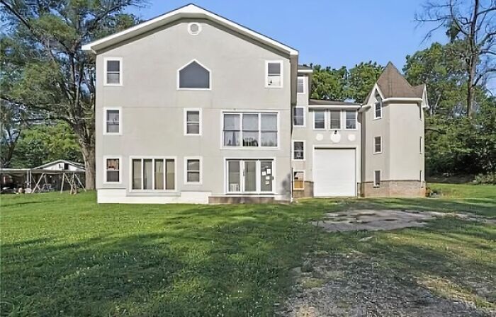 A house with mismatched architectural styles and windows, representing significant architecture and design fails.