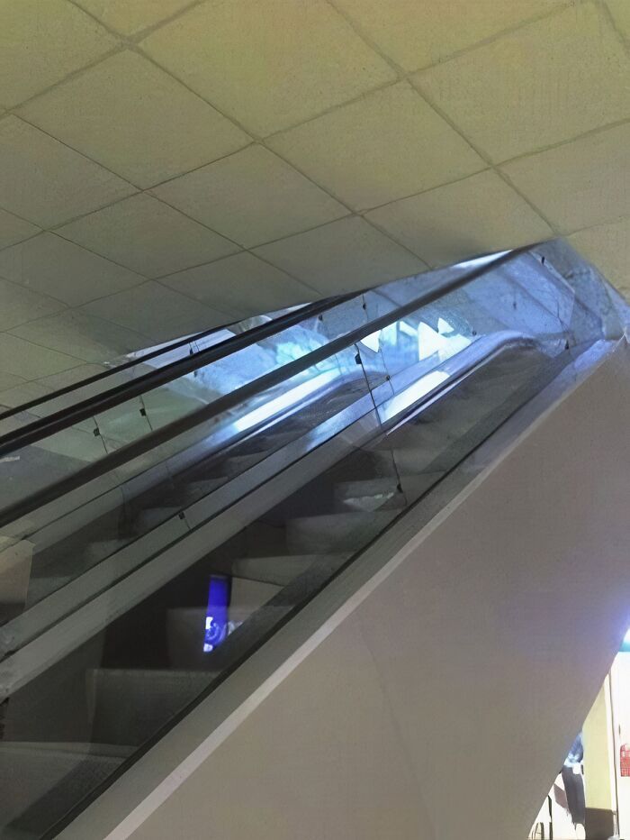 An escalator leading to a wall, highlighting an architecture and design fail in public spaces.