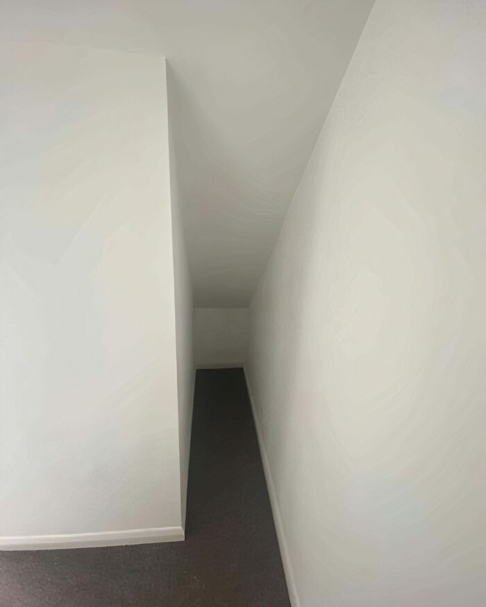 An awkward, narrow hallway leading to a small, enclosed space, highlighting architecture and design fails.