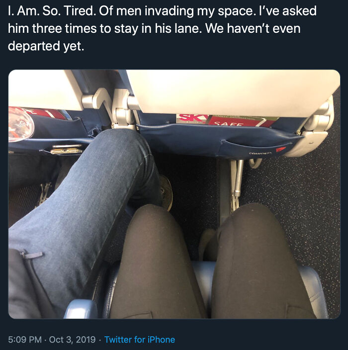 An infuriating story of entitled men invading personal space on an airplane, showing legs of two passengers.