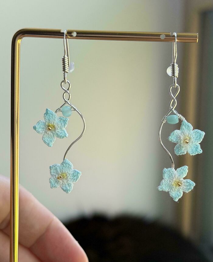 Delicate crochet enthusiasts' earrings featuring light blue flowers, an incredible piece of handmade jewelry.