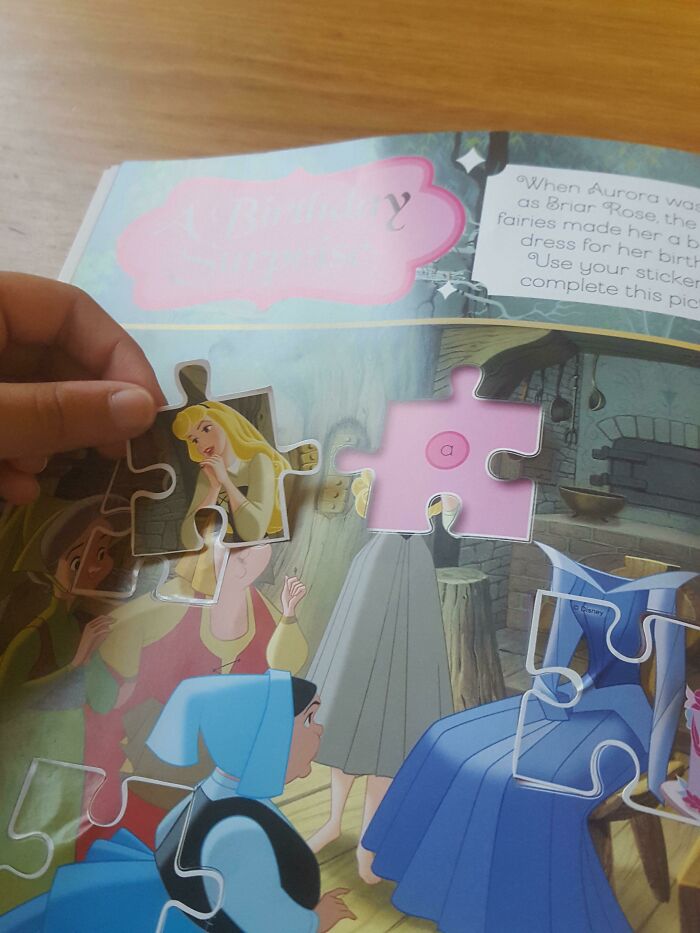 A hand holding a puzzle piece that clearly doesn't fit into the designated spot on the page, a funny fail.