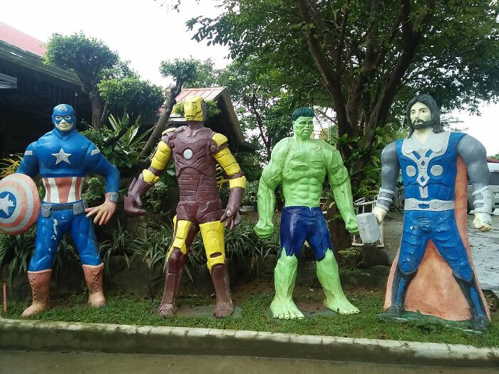 Four mismatched superhero statues, including Captain America and Hulk, demonstrating a humorous common sense fail.