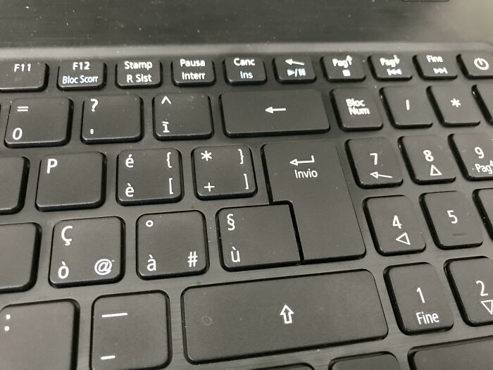 A laptop keyboard with the Enter key incorrectly placed, illustrating a ridiculous manufacturing fail.