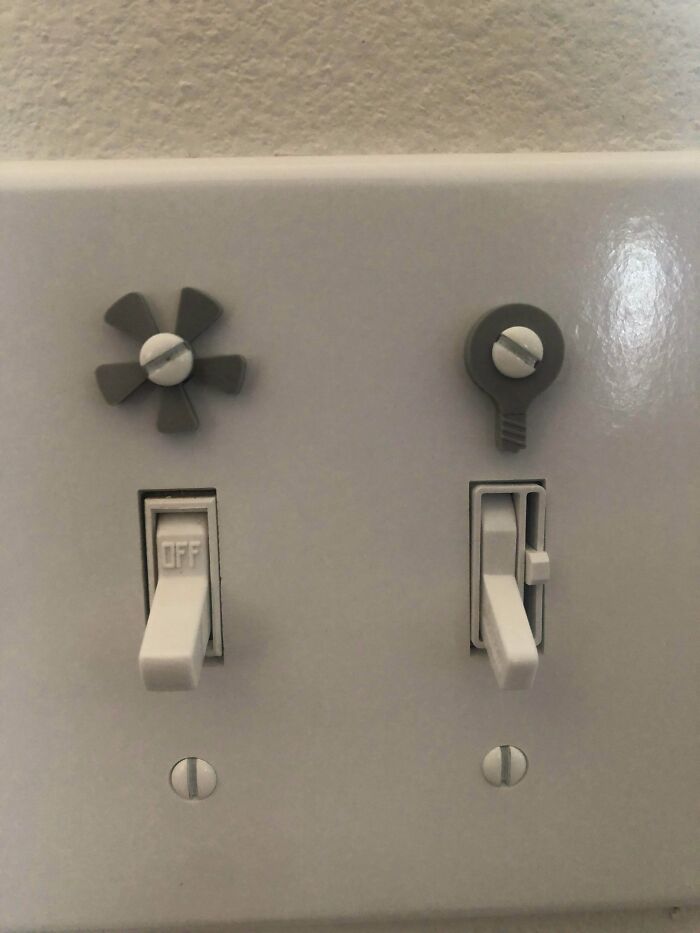 White light switches adorned with unique gray functional 3D prints, making everyday life much easier and adding personality.