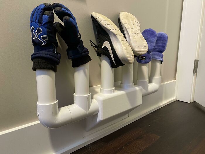 A white PVC functional 3D print shoe and glove dryer mounted on a wall, making everyday life much easier.