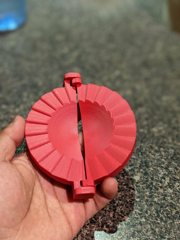 A red, round, functional 3D print, likely a dough press for making everyday life easier in the kitchen.