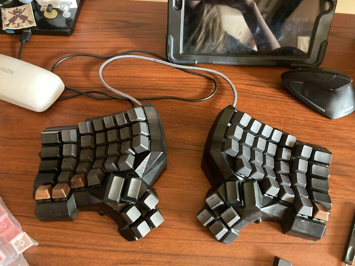 A split ergonomic keyboard, a functional 3D print, sitting on a desk, simplifying everyday life.