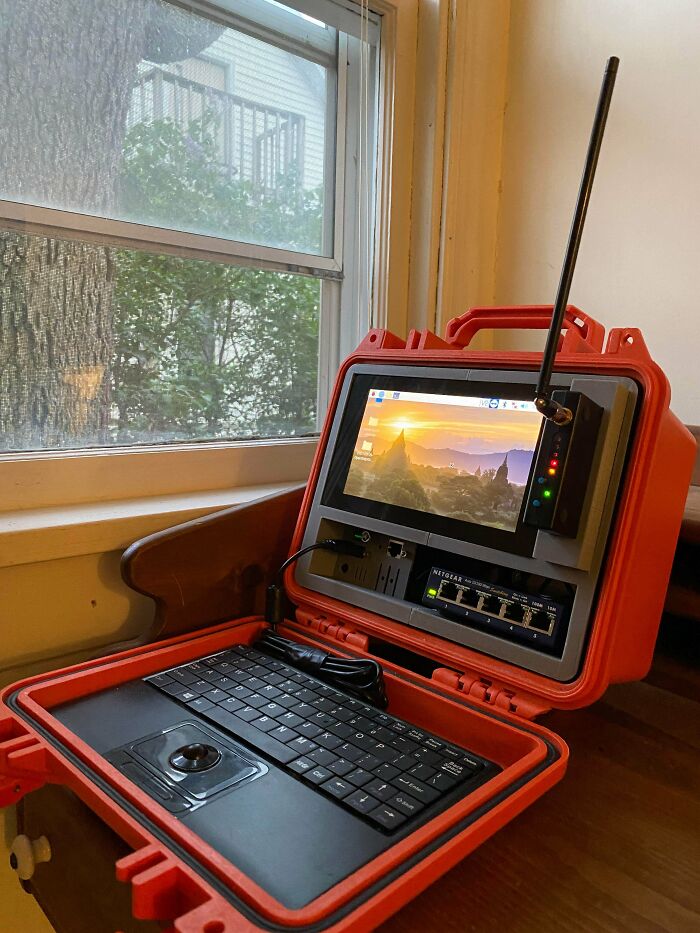 Orange Pelican case with a screen and keyboard, a functional 3D print for portable computing ease.