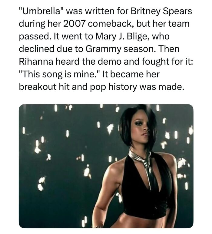 Pop culture post: Rihanna in a black halter top and silver tie, from the music video for her hit song Umbrella.