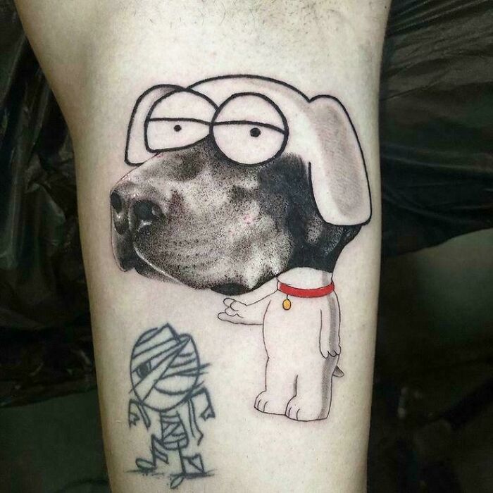 A tattoo artist's talent is wasted on a questionable tattoo idea featuring a dog with a human face and a small mummy.