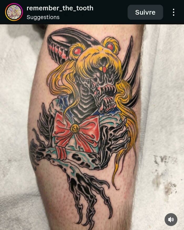 A detailed tattoo of an Alien-Sailor Moon hybrid with sharp claws and teeth, demonstrating a tattoo artist's talent.