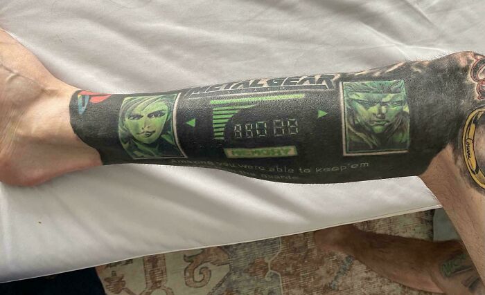 A detailed Metal Gear Solid video game tattoo on a leg, showcasing a tattoo artist's talent.