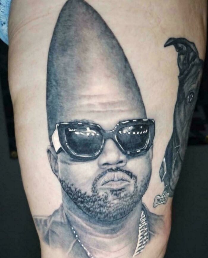 A tattoo artist's talent is wasted on a questionable tattoo idea of Kanye West with a cone head on a person's thigh.