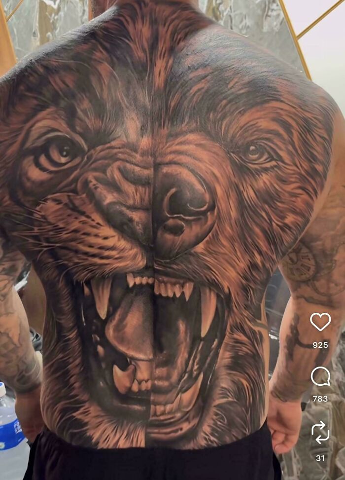 This tattoo artist's talent is showcased in a full back tattoo of a roaring lion's face, displaying detailed fur and teeth.