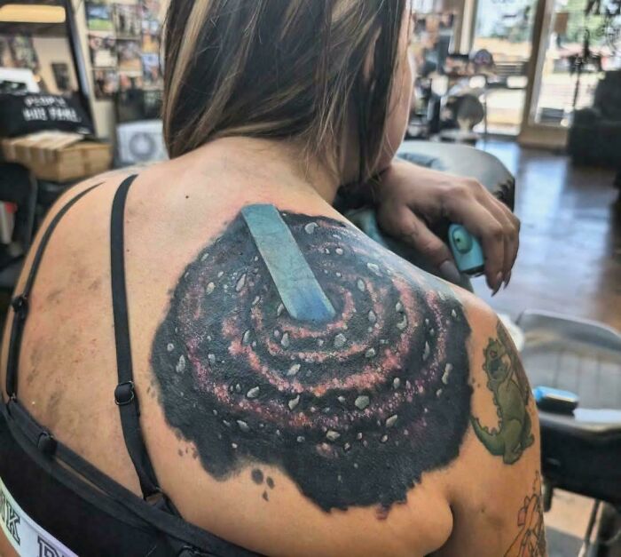 Galaxy swirl tattoo artist design on a woman's shoulder, questionable ideas.