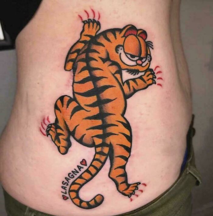 Garfield as a tiger tattoo artist design with word lasagna, questionable ideas.