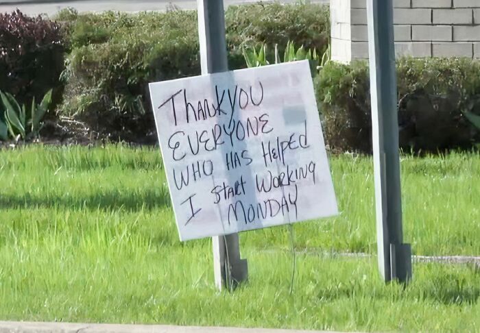 A handwritten sign on a pole says Thank You Everyone Who Has Helped I Start Working Monday, a soul-healing message.