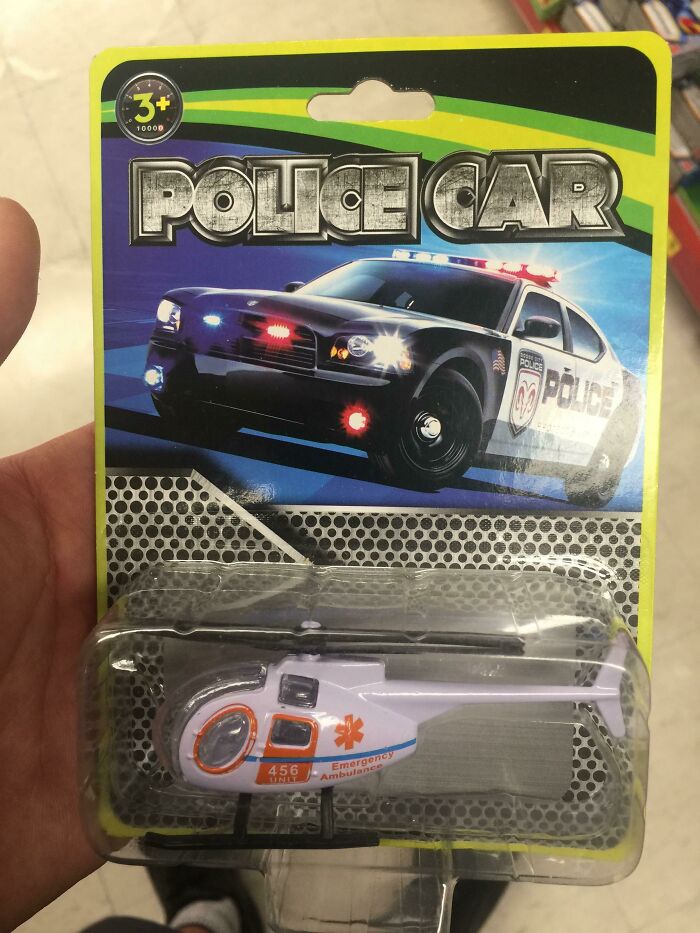 A toy package labeled Police Car displaying a helicopter toy inside, highlighting a ridiculous common sense fail.