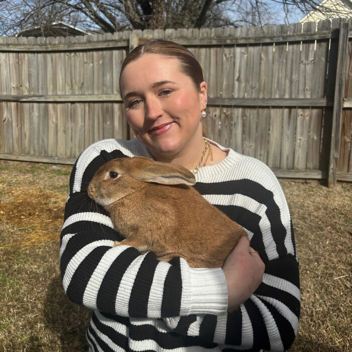 Mom in low-income family holding pet rabbit outdoors Mom in low-income family holding pet rabbit outdoors