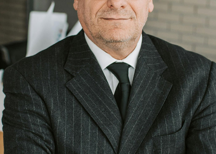 Middle-aged man wearing a suit and tie representing a professional figure