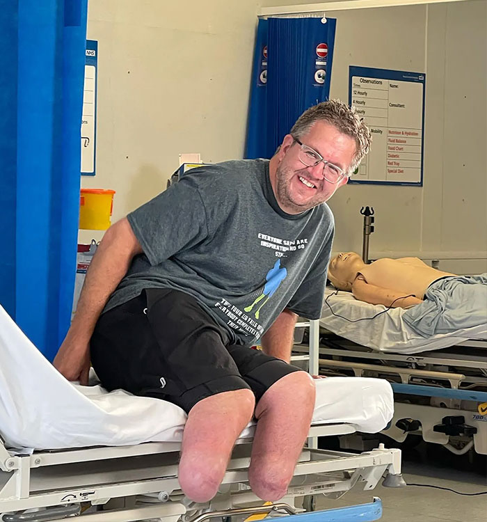 Smiling man with amputated legs on hospital bed related to professional surgeon news Smiling man with amputated legs on hospital bed related to professional surgeon news