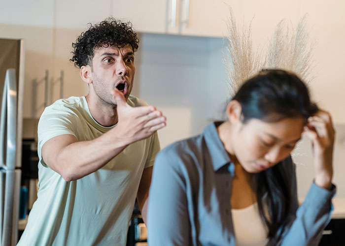 Couple arguing in kitchen showing life mistakes causing relationship strain