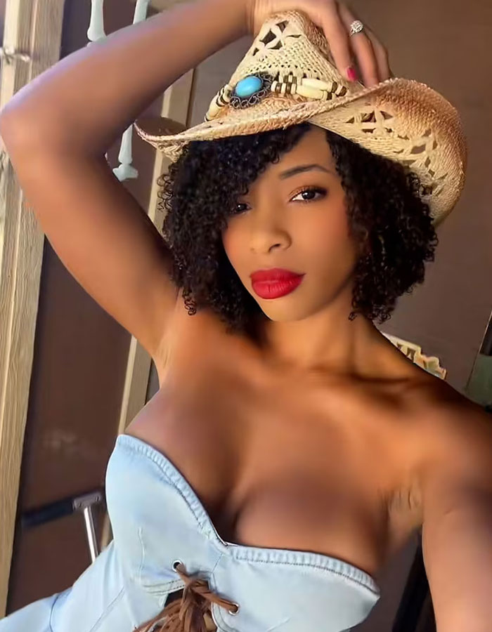 California housewife wearing a cowboy hat and denim top posing confidently California housewife wearing a cowboy hat and denim top posing confidently
