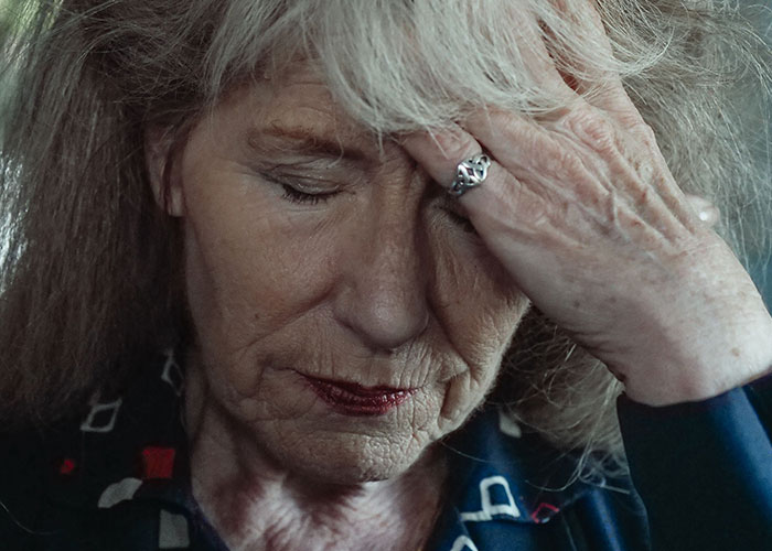Stressed older woman feeling marriage tension from mother in law