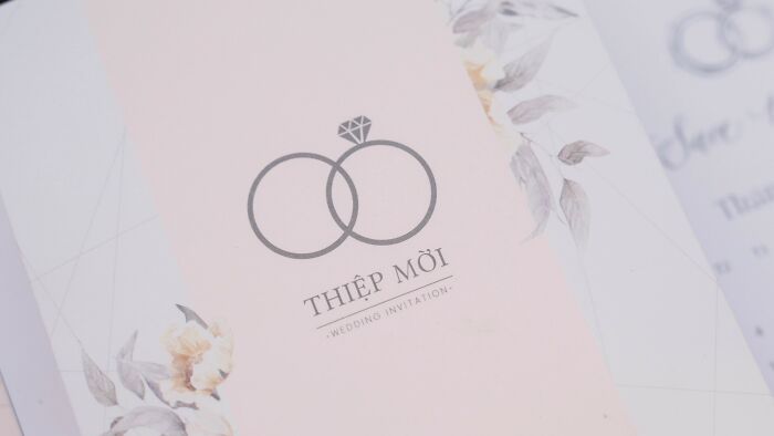 Close-up of elegant wedding invitation card with floral design