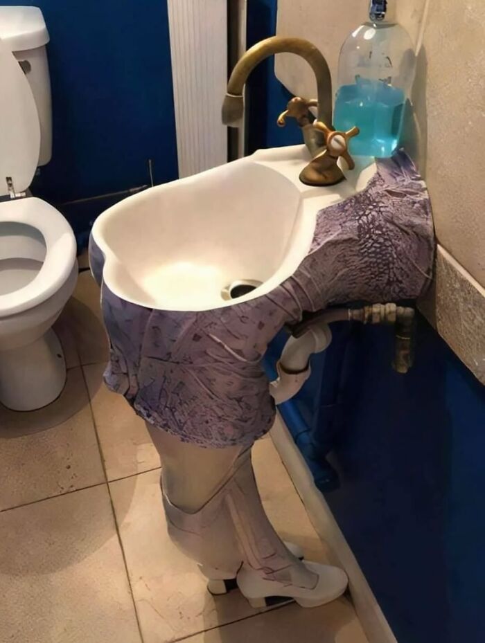 Cringeworthy design fail of bathroom sink painted to look like legs wearing pants and shoes