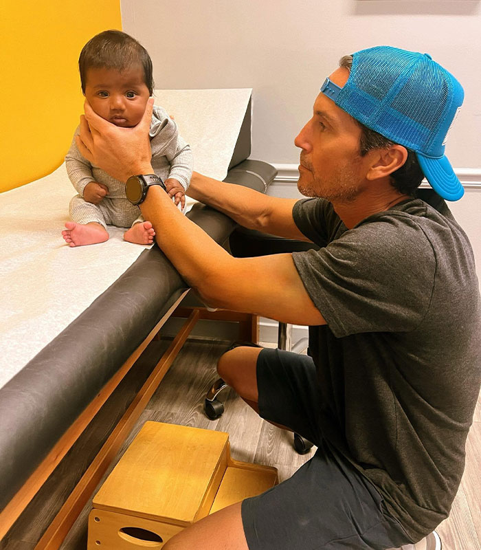 A man holding a baby who was born after an IVF mix-up, highlighting the couple who gave birth to the wrong baby. A man holding a baby who was born after an IVF mix-up, highlighting the couple who gave birth to the wrong baby.