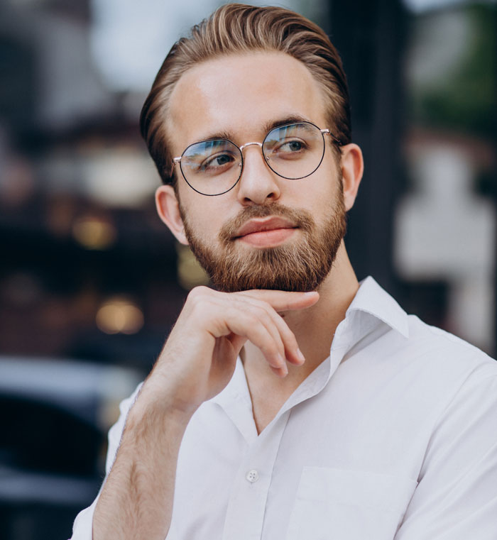 A thoughtful man with a beard and glasses, symbolizing myths about men.