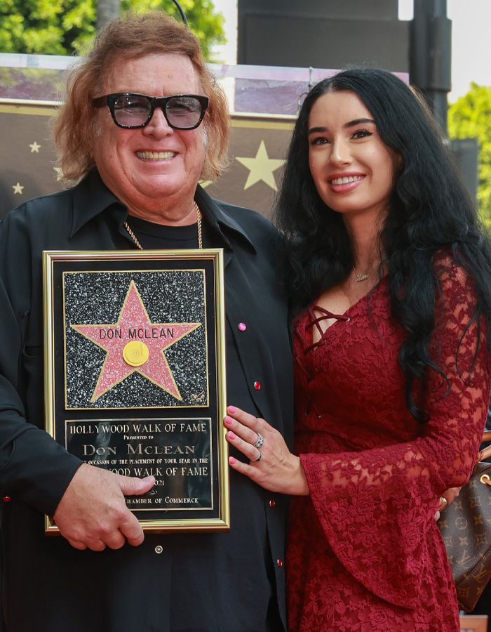 Music idol Don McLean with younger woman holding a Hollywood Walk of Fame star plaque