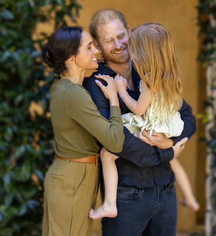 Meghan Markle and Prince Harry embracing their kids, with Lilibet being held, raising concern for her. Meghan Markle and Prince Harry embracing their kids, with Lilibet being held, raising concern for her.