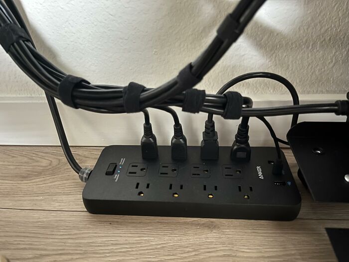 An Anker power strip with multiple cords plugged in, showcasing effective Prime Day electronics deals.